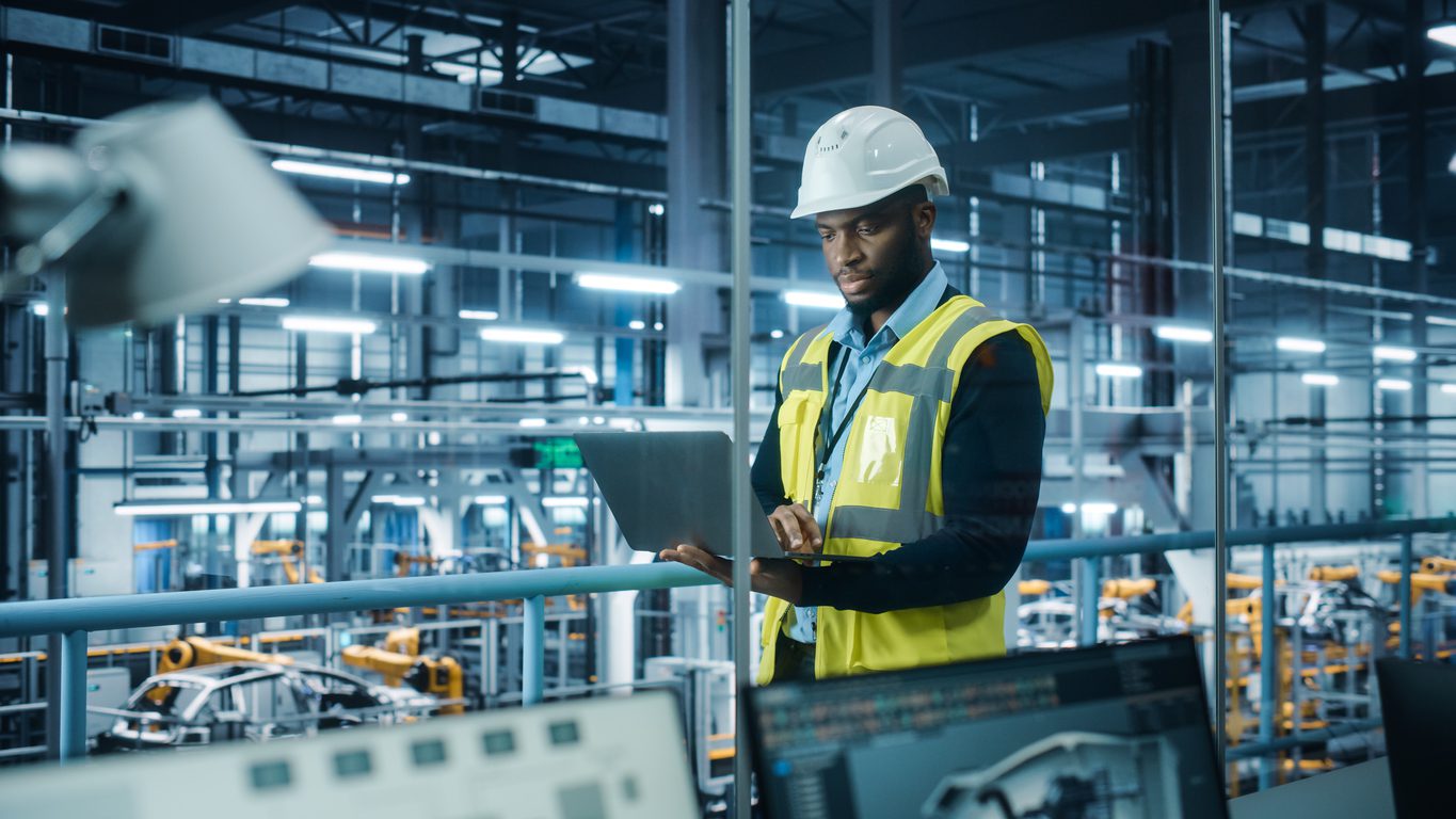 Image of a technician monitoring building equipment with connected technology.